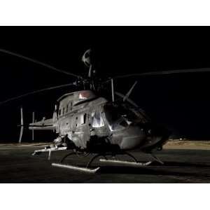  OH 58D Kiowa Sits on its Pad at Night Premium Poster Print 