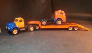 FIRST GEAR INT. ROADWAY TRACTOR WITH A LOWBOY TRAILER AND A CITY TRUCK 