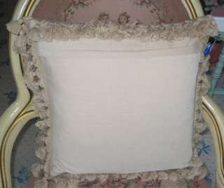   tan background pillow is trimmed all around with an elegant plush tan