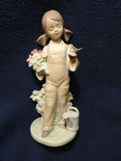 Lladro   Spring Flowers Girl. Girl with her gard flowers holding a 