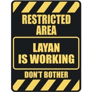   RESTRICTED AREA LAYAN IS WORKING  PARKING SIGN