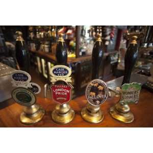 England, London, Beer Pump Handles at the Bar Inside Tradional Pub by 