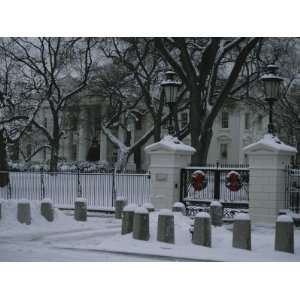 Christmas Wreaths Add a Touch of Color to Snow Covered White House 